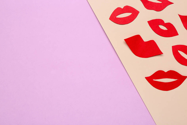 Red paper lips on color background - Fotografie, Obrázek