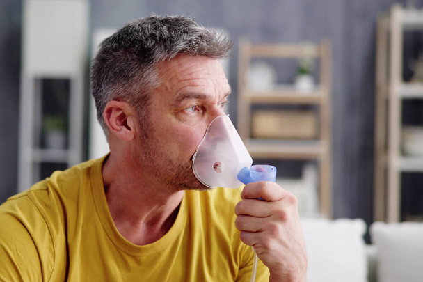 Asthma Patient Breathing Using Oxygen Mask And COPD Nebulizer - 写真・画像