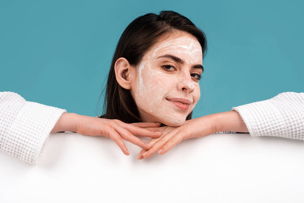 Beautiful girl model with facial mask cream, isolated. Banner with copy space - 写真・画像