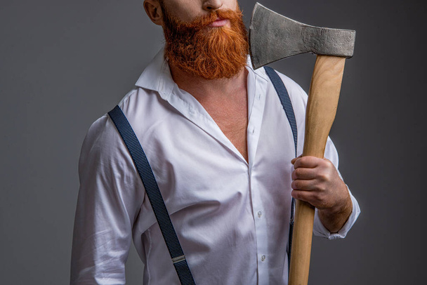 masculinity of man with axe in studio, cropped view. masculinity of man with axe on background. photo of masculinity of man with axe. masculinity of man with axe isolated on grey. - Foto, Bild