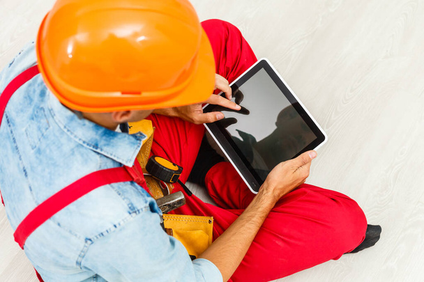 Builder Holding Digital Tablet On White Background - Valokuva, kuva