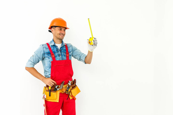 Worker in hard hat measure with ruler. Isolated on a white background. - Photo, Image