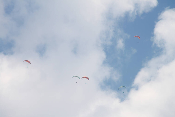 Paragliding sport among the clouds - Фото, изображение