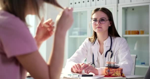 Arzt hört sich Frauenproblem über Splittergruppen in Klinik an Pharmakologische Produkte für Haarsanierungskonzept - Filmmaterial, Video