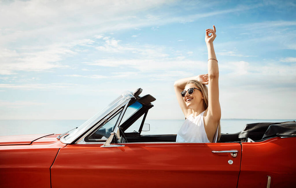Loving this life. a happy young woman enjoying a summers road trip - Photo, Image