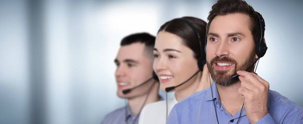 Hotline operators with headsets in office, space for text. Banner design - Foto, Bild