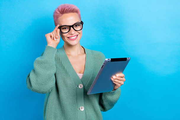 Photo of attractive secretary woman short hair touch glasses wear green shirt hold tablet browse news isolated on blue color background. - Foto, afbeelding