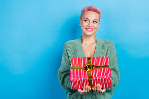 Photo of cheerful positive lady wear stylish clothes hold gift box look empty space special season deal isolated on blue color background. - Foto, afbeelding