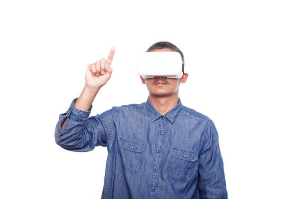 Man wearing virtual reality headset isolated on white background,  trying finger to touch screen something - Фото, изображение