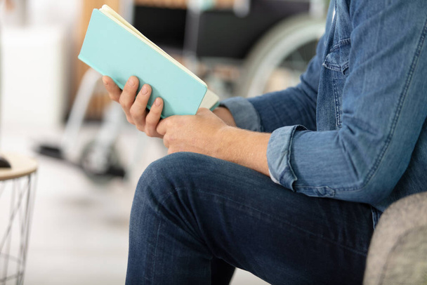 disabled man in wheelchair reading a book - Photo, image