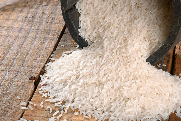 white rice natural long rice grain in wooden bowl use texture background - Photo, Image