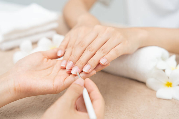 Woman receive care service by professional Beautician Manicure at spa centre. Nail beauty salon use nail file for Glazing treatment. manicurist make nail customer to beautiful. body care spa treatmen - Photo, Image