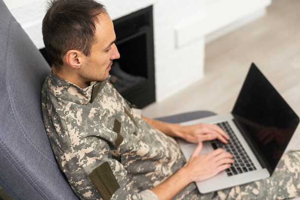 Young military soldier man portrait with laptop on background - Foto, immagini