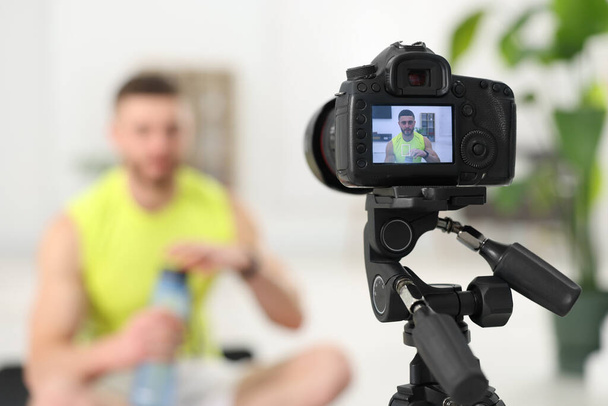 Trainer recording fitness lesson at home, focus on camera. Space for text - Photo, Image