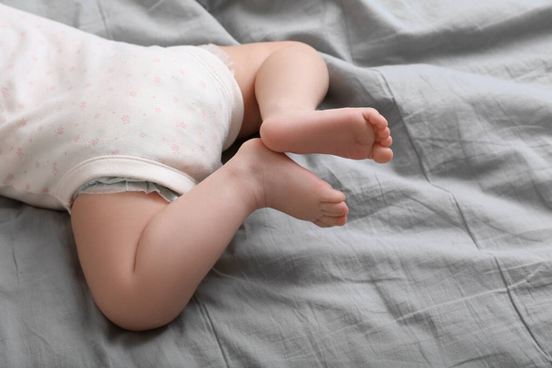 Little baby lying on bed, closeup view - 写真・画像
