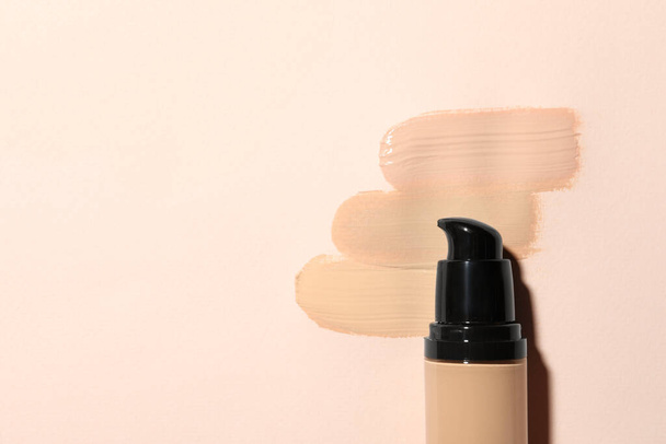 Liquid foundation and swatches on beige background, top view. Space for text - Photo, Image