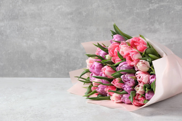 Bouquet of beautiful tulips on white table. Space for text - Foto, Imagem
