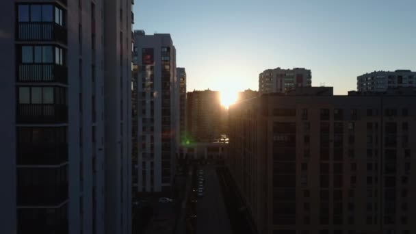 明るい太陽の美しい街路のトップビュー. ストック映像。 日光は住宅街の建物で街路を照らしています. 晴れた朝のモダンな住宅複合施設と都市エリア. - 映像、動画