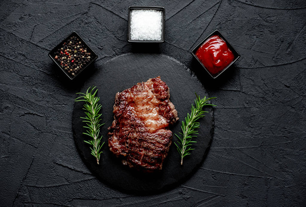 grilled beef steak with spices on black background - Photo, Image