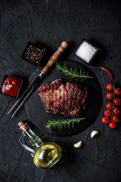 grilled beef steak with spices on black background - Φωτογραφία, εικόνα