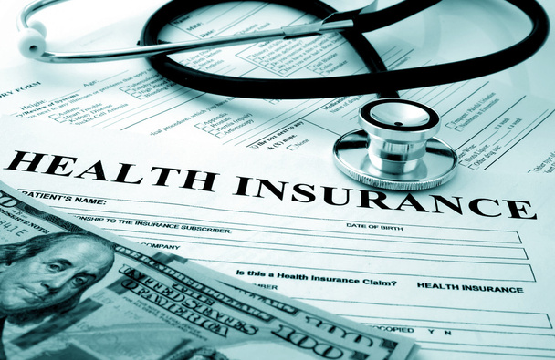 Health insurance form with dollars and stethoscope - 写真・画像