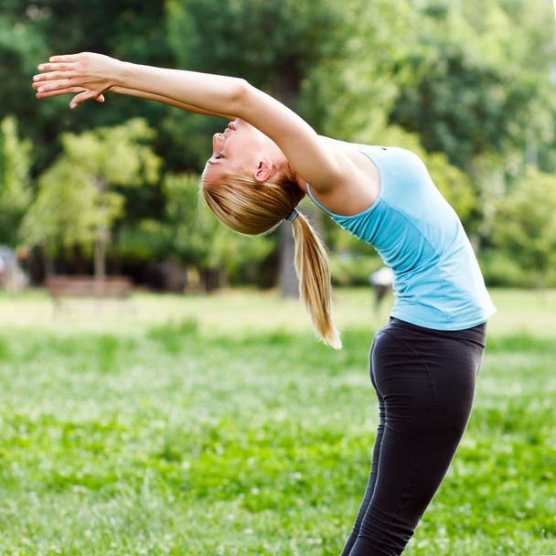 Woman exercising in the park - Photo, image