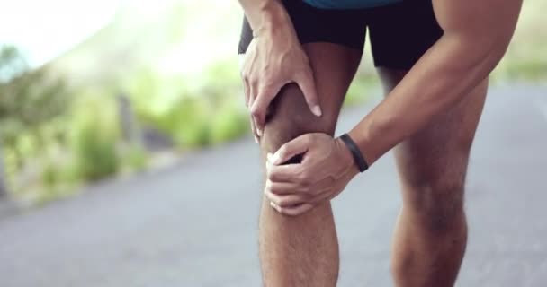 Injury, hurt and man with knee pain while training, exercise and workout outdoors with an emergency due to muscle discomfort. Fitness, accident and injured person or athlete with inflammation. - Footage, Video