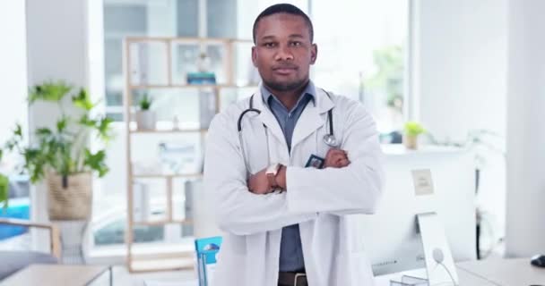Crossed arms, doctor and face of black man in hospital for trust, life insurance and healthcare support. Professional, clinic and portrait of serious male worker for medical care, service and help. - Footage, Video