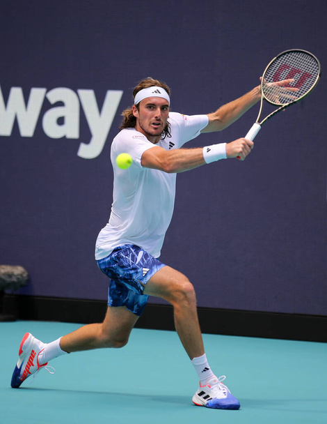 MIAMI GARDENS, FLORIDA - MARCH 27, 2023: Stefanos Tsitsipas of Greece in action during round 3 match against Cristian Garin of Chile at 2023 Miami Open at the Hard Rock Stadium in Miami Gardens, Florida, USA - Photo, Image