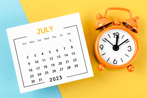 July 2023 Monthly calendar for 2023 year with alarm clock on beautiful background. - Foto, Bild