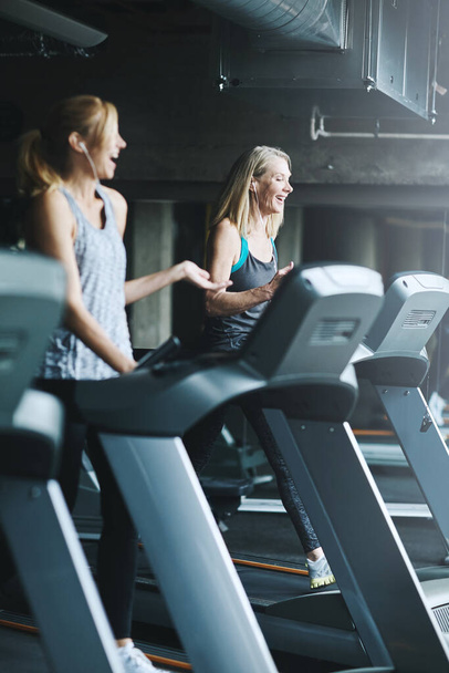 Running can be fun if you have great company. mature women working out in the gym - 写真・画像