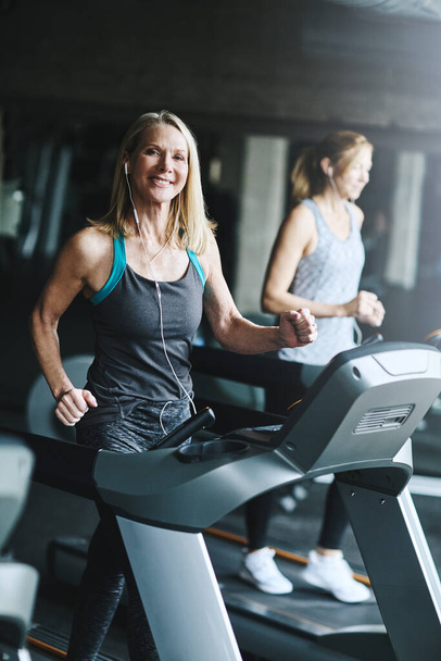 Getting fit to live a better lifestyle. mature women working out in the gym - Photo, Image