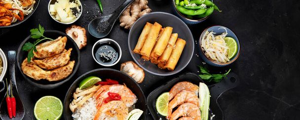 Various  asian meals dishes on black background , top view. Asian food concept. Copy space - Фото, изображение