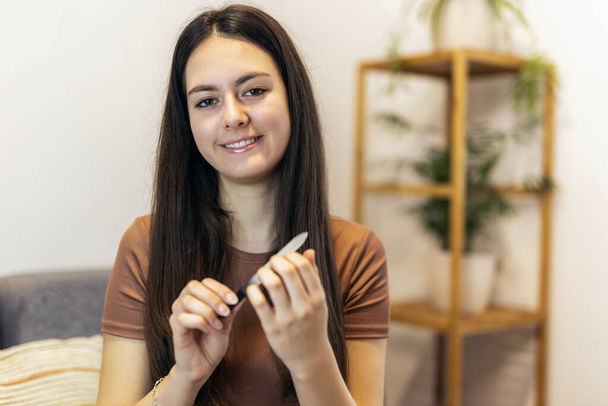  Women's nails and nail file. Self-manicure at home for yourself. - Fotografie, Obrázek