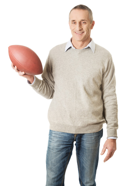 Mature man holding a rugby ball - Фото, зображення