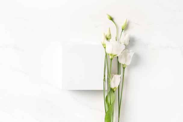 Summer minimal scene for beauty cosmetic product presentation template made with white cube and Lysianthus flower on white background. - Fotoğraf, Görsel