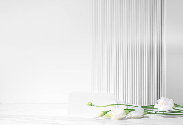 Summer minimal scene for beauty cosmetic product presentation made with white cube podium and Lysianthus flower on white background. - Valokuva, kuva