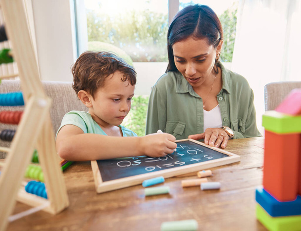 Child, mother and chalkboard writing for math, numbers and home school development of happy family, help and support. Biracial woman or mom and kindergarten kid with learning, teaching and education. - Foto, immagini