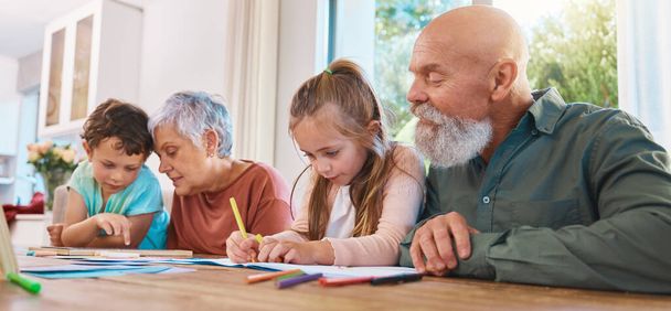 Family, homework and education with children writing, learning or drawing with colors and grandparents. Kids, school or study with kids, senior man and woman in their home for growth or development. - Photo, image
