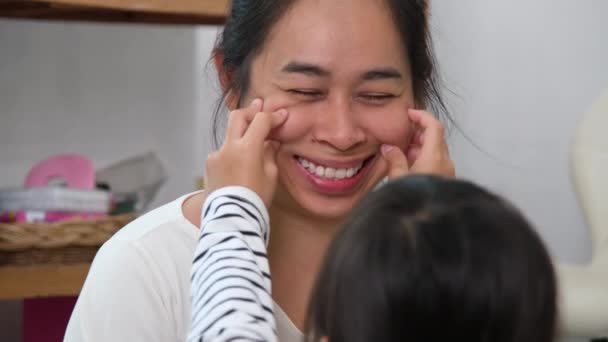 Mother and her daughter playing and hugging. Smiling mother and funny little daughter having fun at home, embracing, sharing tender moments together. Happy loving family and Mother's Day concept. - Footage, Video