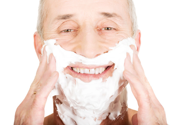 Mature man applying shaving foam - Фото, изображение
