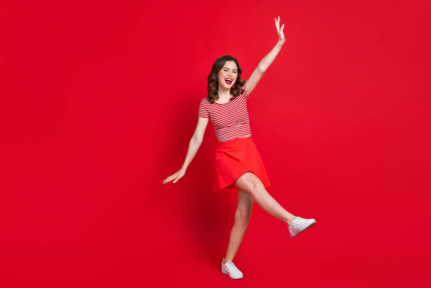 Full length photo of overjoyed positive lady wear trendy clothes rejoicing summer season empty space isolated on red color background. - Foto, afbeelding