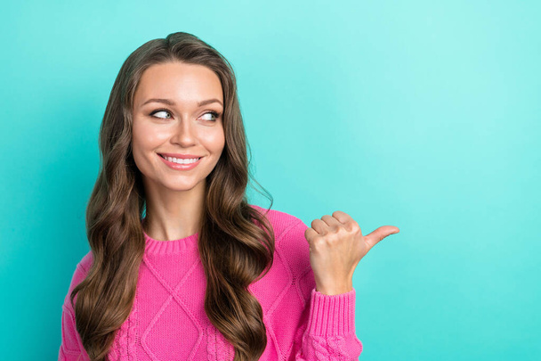 Portrait of cheerful stunning pretty lady wear trendy pink clothes thumb presenting nice offer isolated on cyan color background. - Фото, зображення