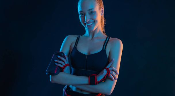 Fit woman influencer at gym. Picture for advertising a fitness club in social networks. Workout for women at home. Cover for sport motivation music. Runner concept. High resolution wallpaper. - 写真・画像