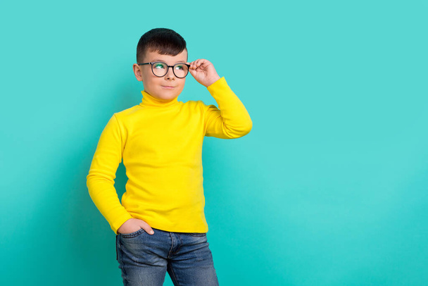 Photo of intelligent boy pupil touch spectacles advertise ads for school garment isolated cyan color background. - Φωτογραφία, εικόνα