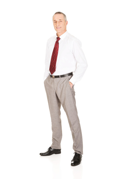 Businessman with hands in pockets - Foto, Bild