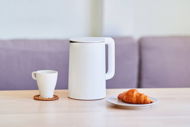 Modern white electric kettle for brewing tea on table at home  - Foto, immagini