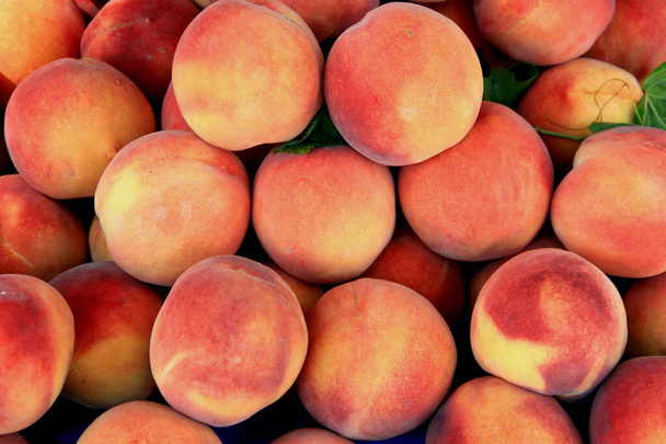 Photo of large juicy ripe sweet orange-pink peaches - Foto, imagen