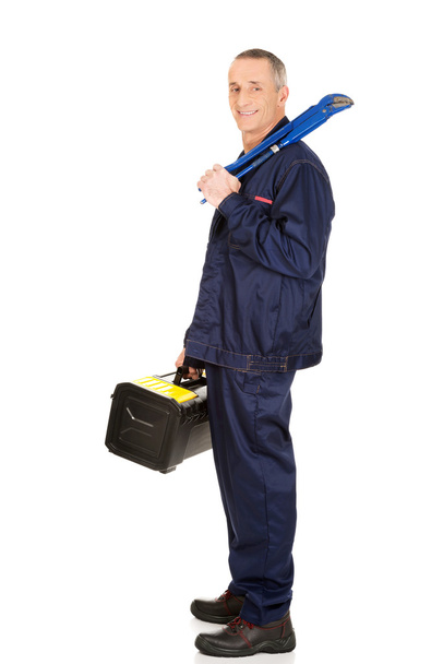 Worker with tools bag and wrench - Foto, imagen