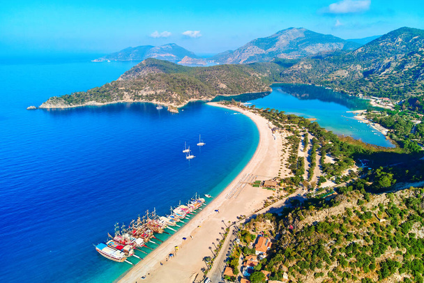 Aerial view of mediterranean sea bay with mountain, sandy beach and boats at sunny day in summer. Drone photo of Blue lagoon in Oludeniz, Turkey - Фото, зображення